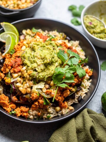 Vegan copycat Chipotle Sofritas burrito bowl ingredients in a black bowl.