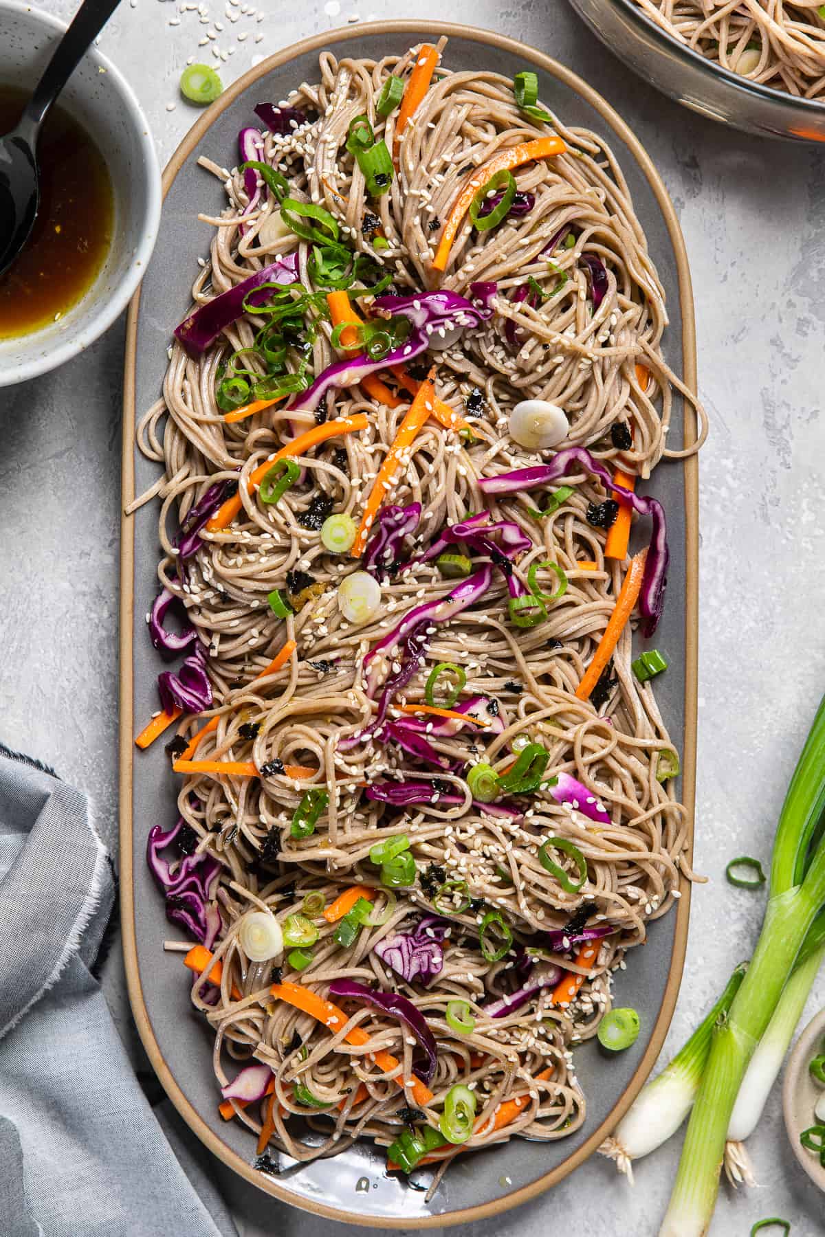vegan easy cold soba noodle salad on a long oval plate.