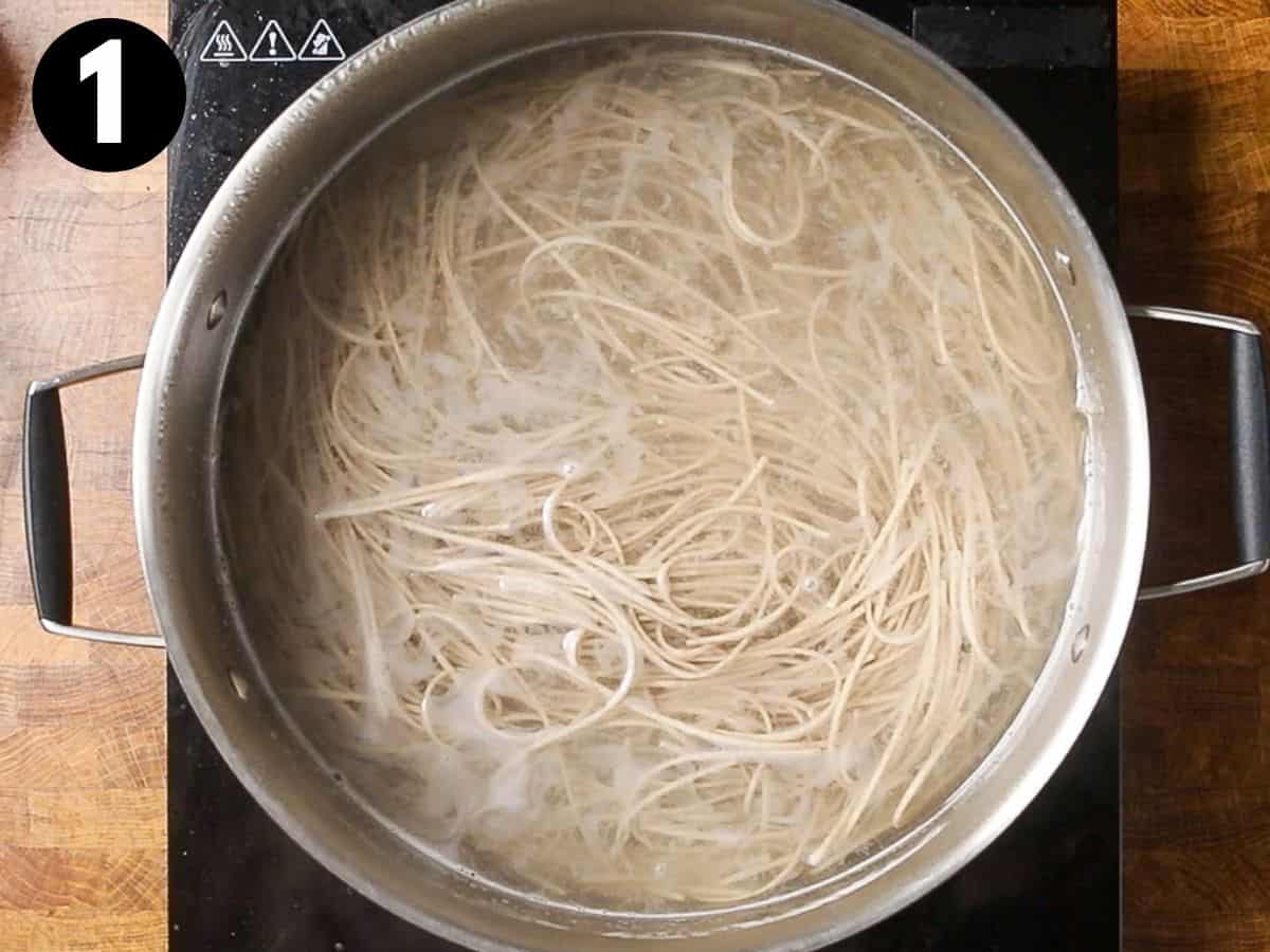 cooking soba noodles in a pot.