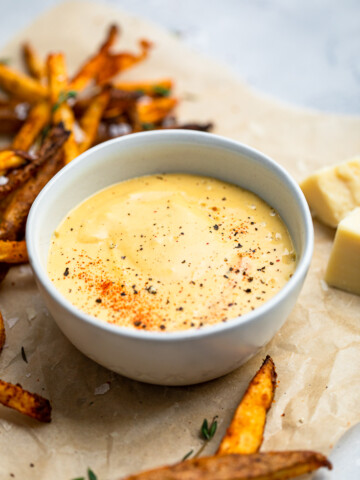 A small bowl with 10 minute easy vegan cheese sauce.