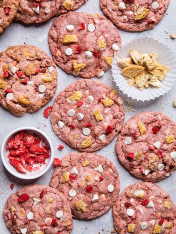 Pink Vegan strawberry shortcake cookies with white chocolate chips and vanilla cookie pieces.
